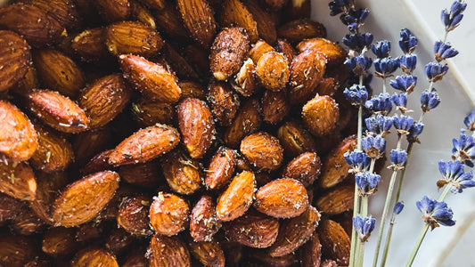 Whole roasted almonds seasoned with lavender and sugar with dried lavender flowers.