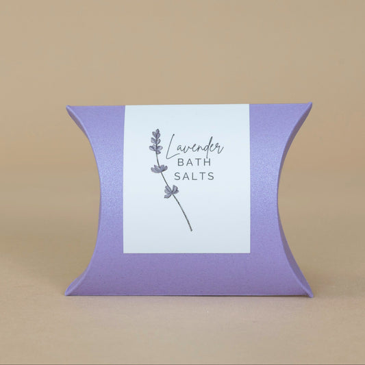 Lavender Bath Salts in a clear jar highlighting the soothing purple crystals for calming baths.