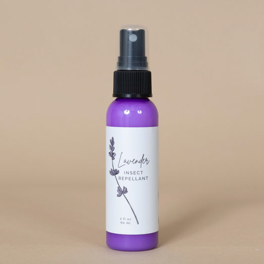 Lavender Insect Repellant spray showcased in an outdoor garden setting next to fresh lavender sprigs