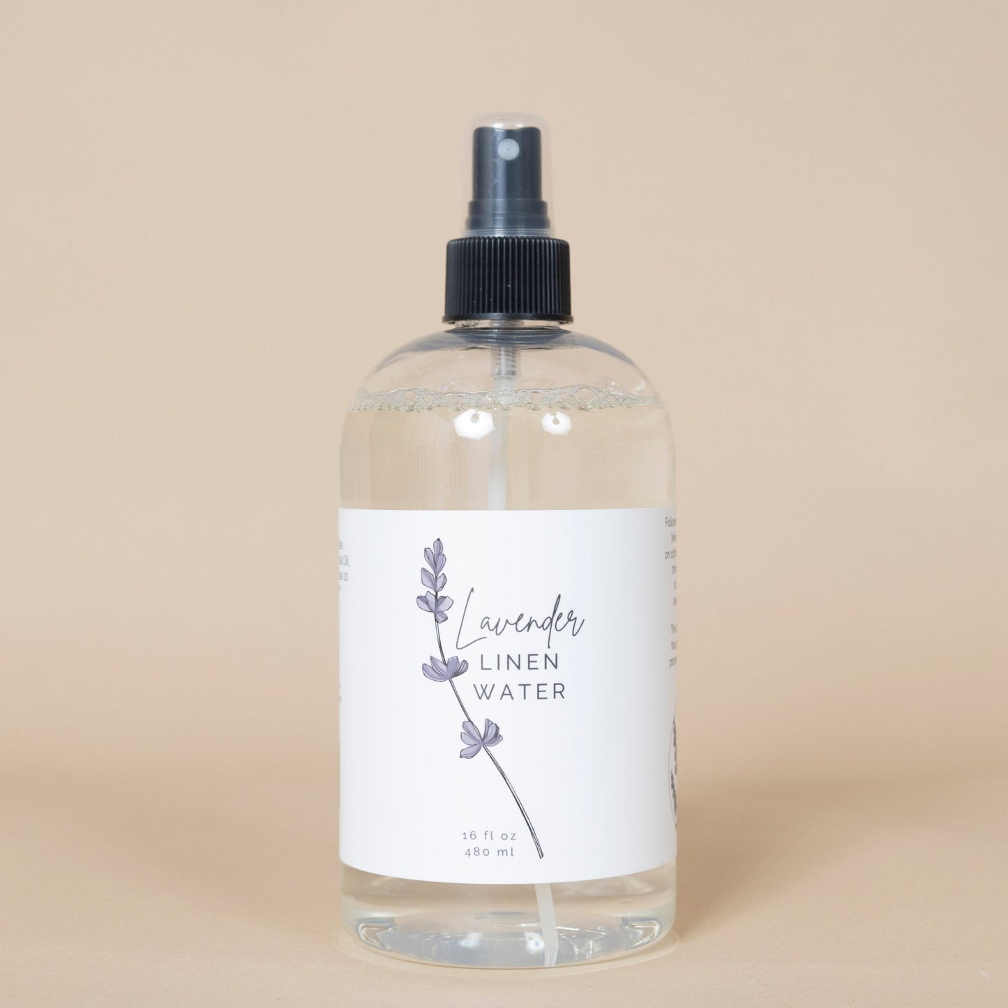 Lavender Linen Water bottle placed in a laundry room setting, perfect for refreshing fabrics