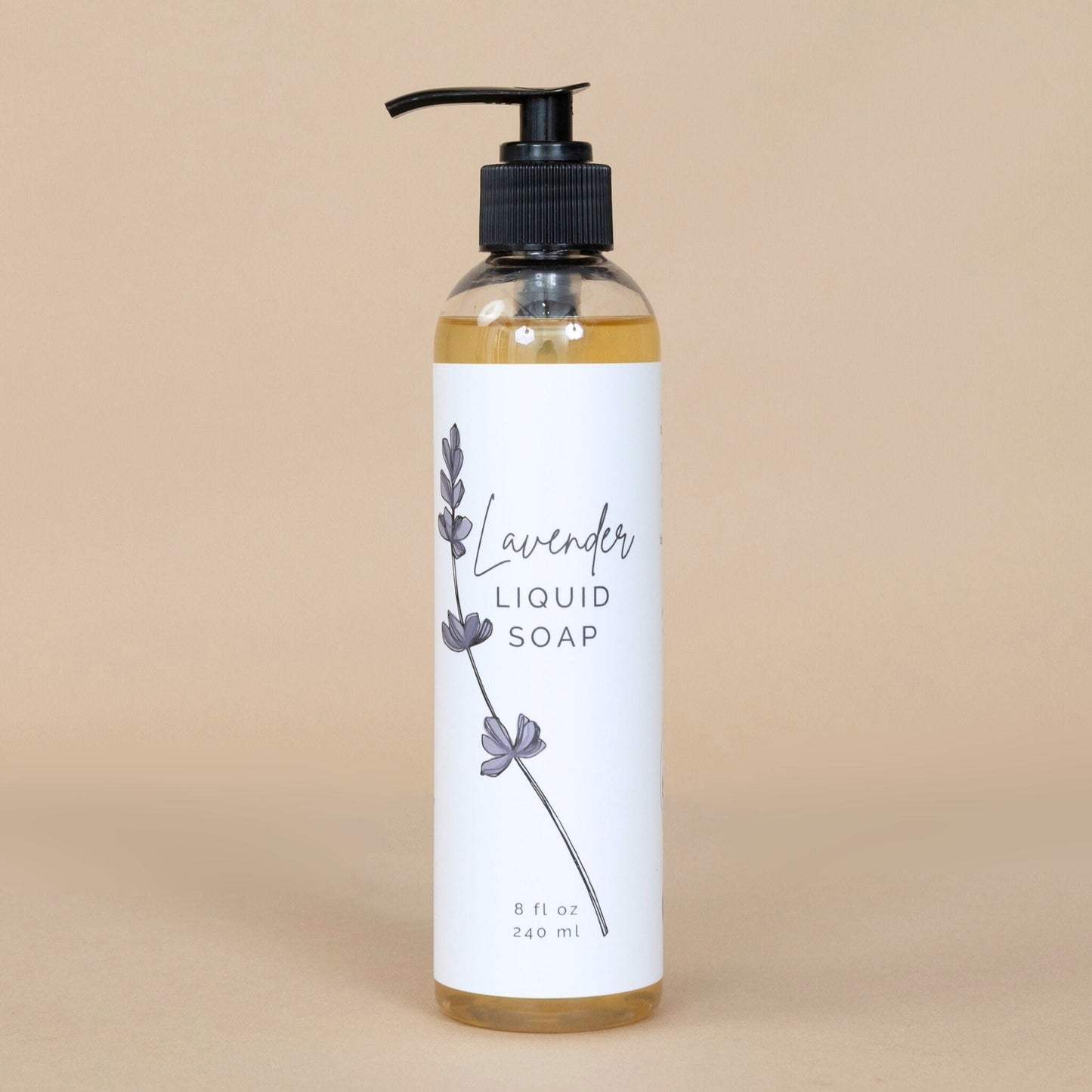 Lavender Liquid Soap in a clear bottle with a pump dispenser, showcasing its soothing purple hue on a clean background