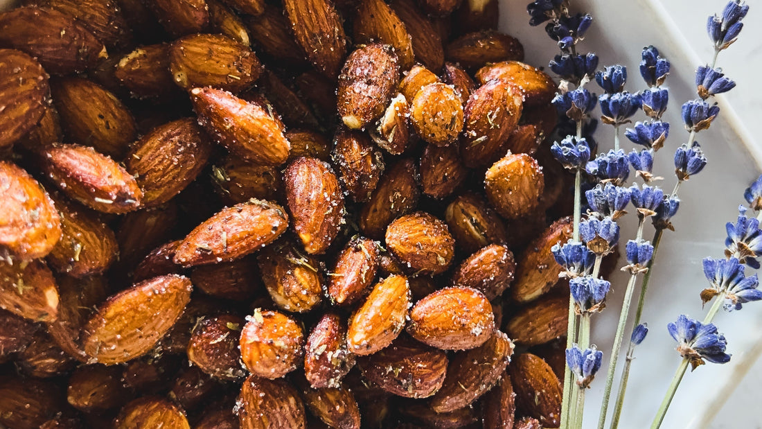 Whole roasted almonds seasoned with lavender and sugar with dried lavender flowers.