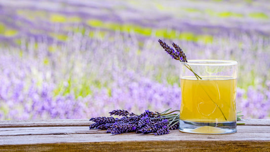 Glass of lavender lemonade with lavender in the background
