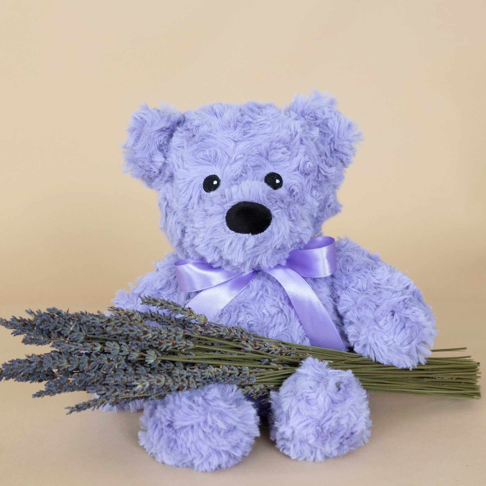 Lavender Aromatherapy Bear in purple plush fabric with a decorative bow, ideal for relaxation and gifting.