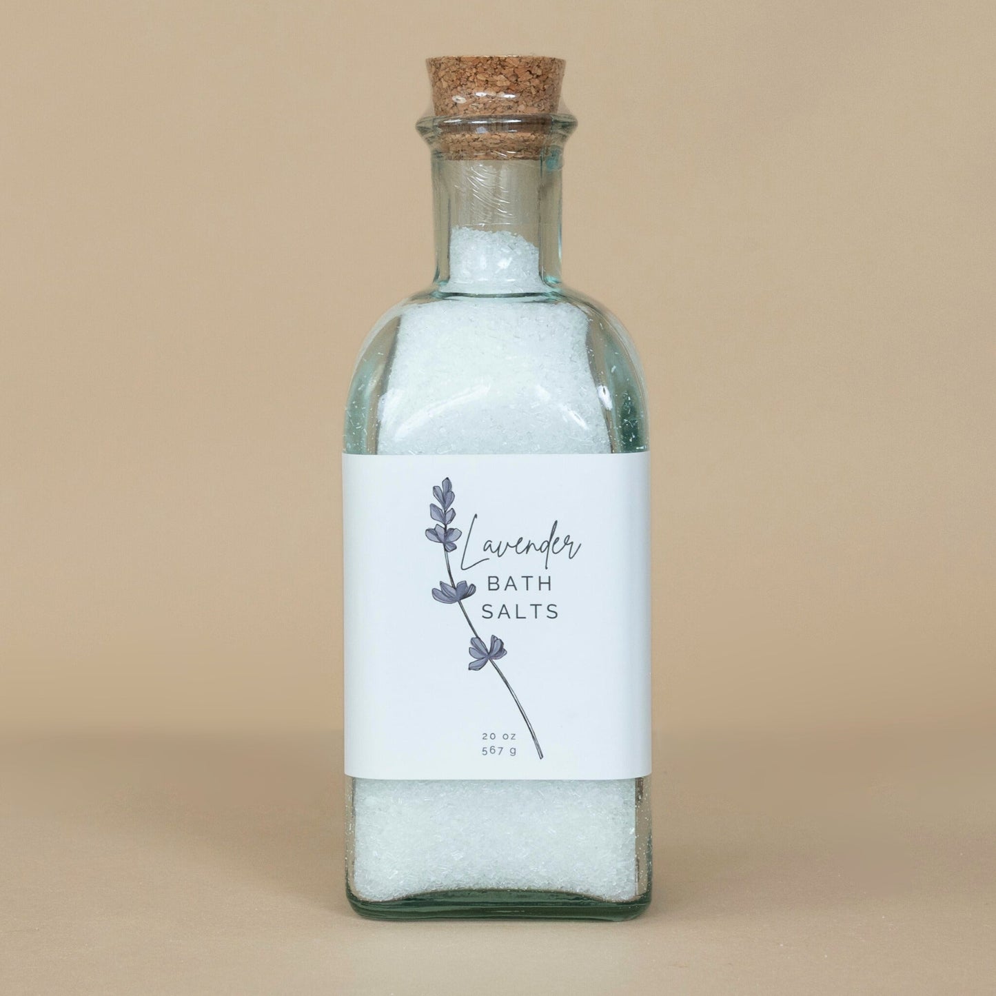 Lavender Bath Salts presented in an open container with a wooden scoop for easy use in your bath routine.