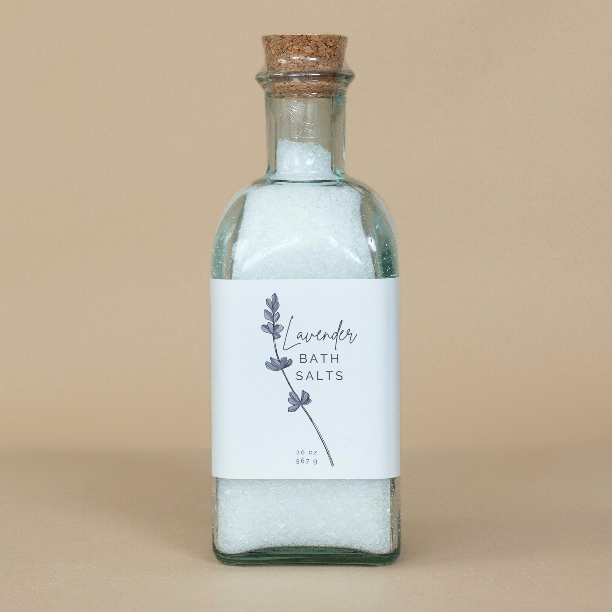 Lavender Bath Salts presented in an open container with a wooden scoop for easy use in your bath routine.