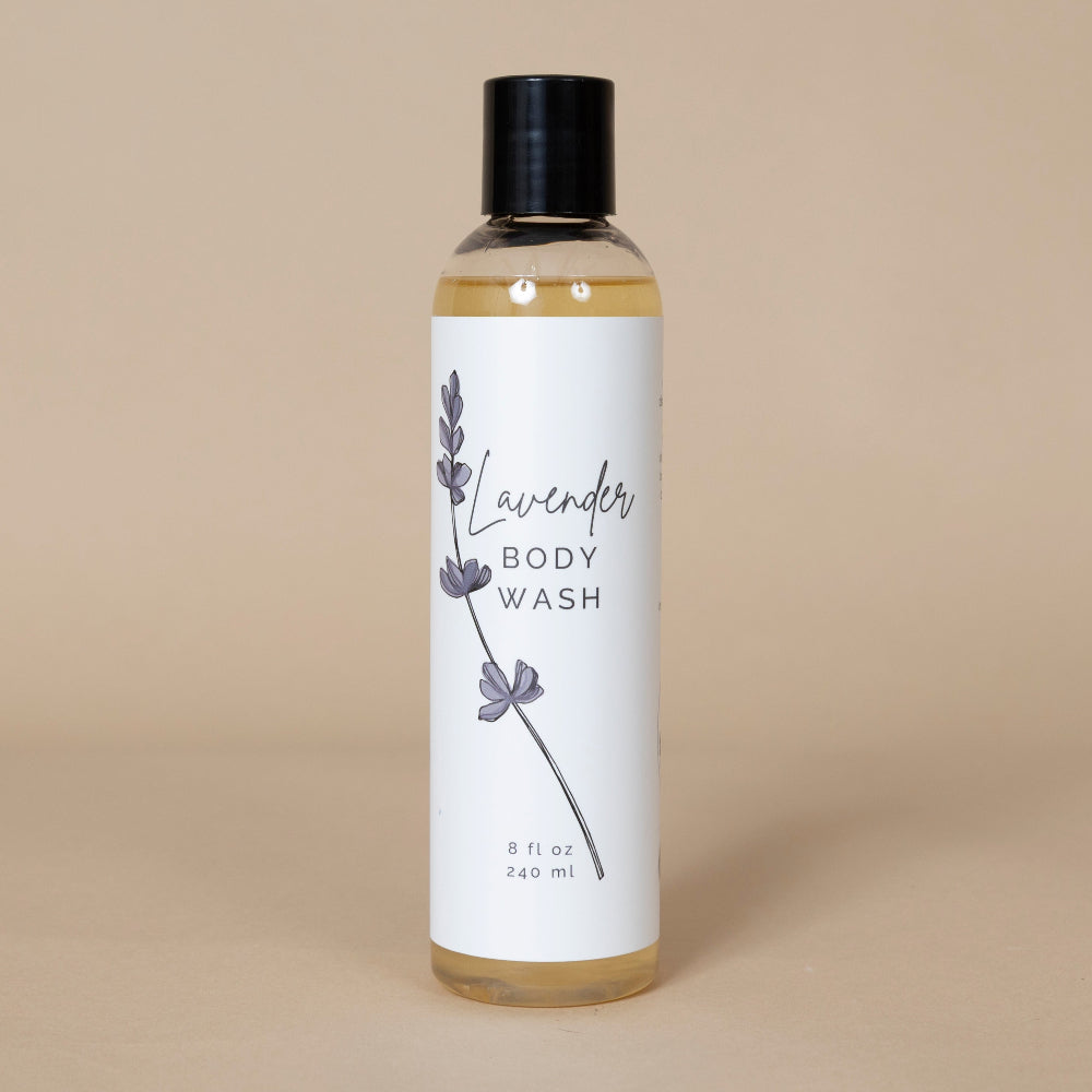 Lavender Body Wash bottle with natural lavender flowers displayed alongside for a soothing bathing experience
