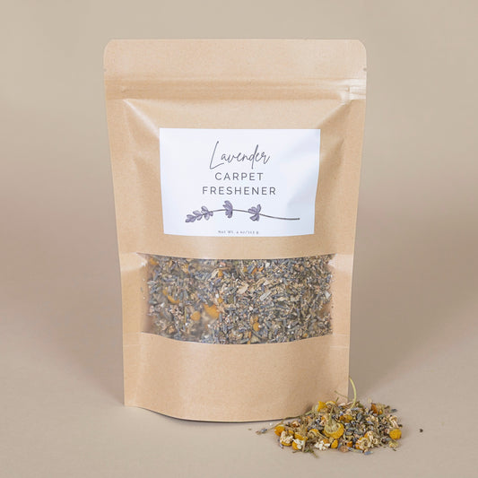 Lavender Carpet Freshener in a kraft paper bag with a label, displayed on a beige background for natural appeal.