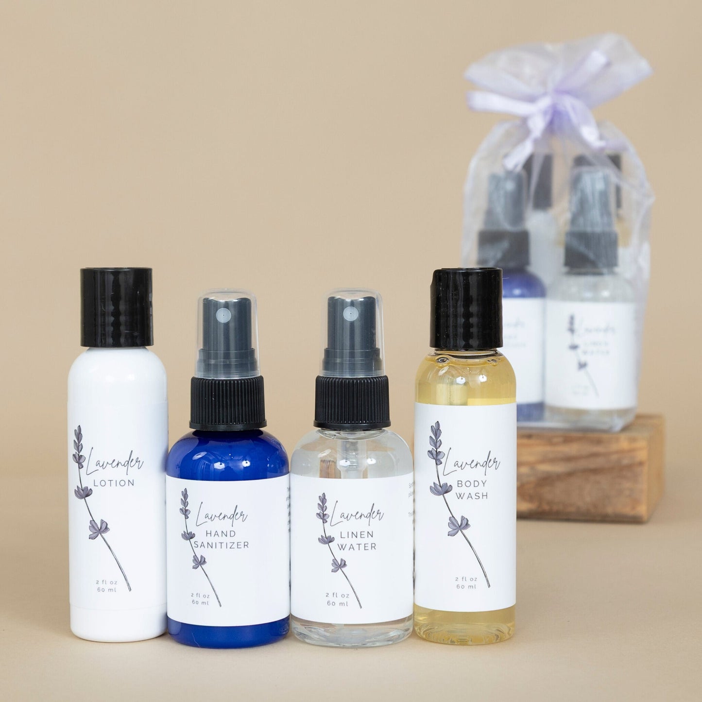 Lavender Carry On Collection personal care set featuring lavender-themed lotion, shampoo, conditioner, and body wash on a beige background.