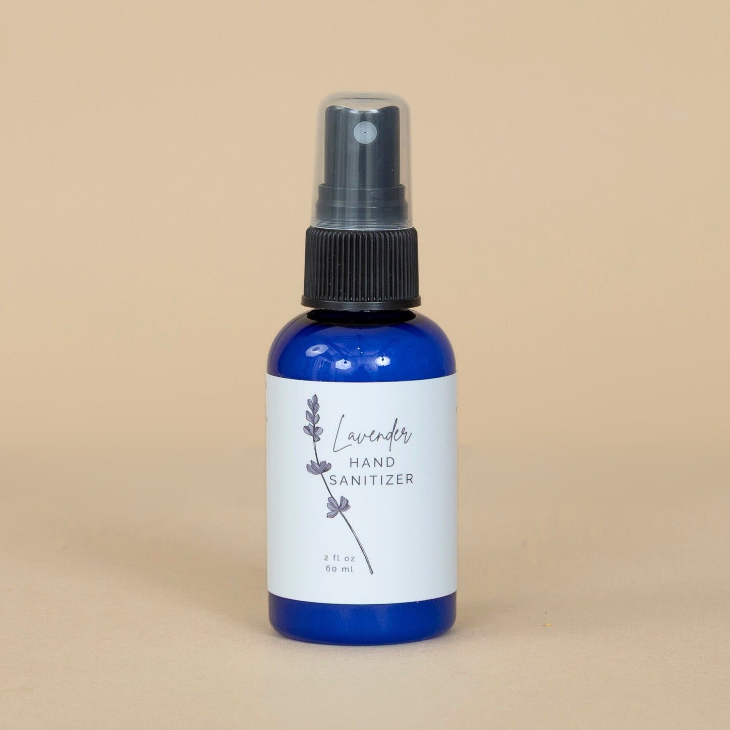 Lavender Hand Sanitizer shown beside fresh lavender flowers emphasizing its soothing, natural scent.