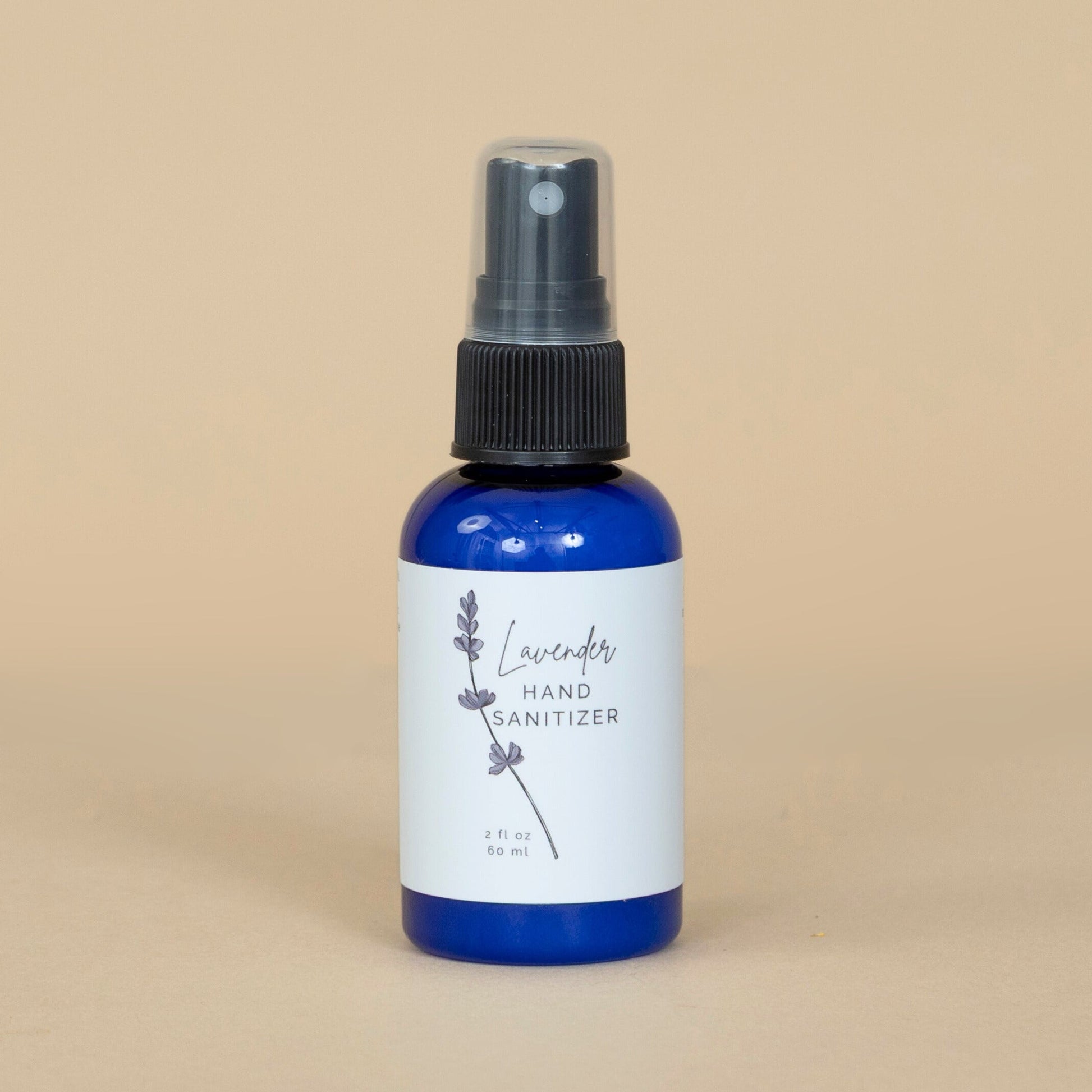 Lavender Hand Sanitizer shown beside fresh lavender flowers emphasizing its soothing, natural scent.