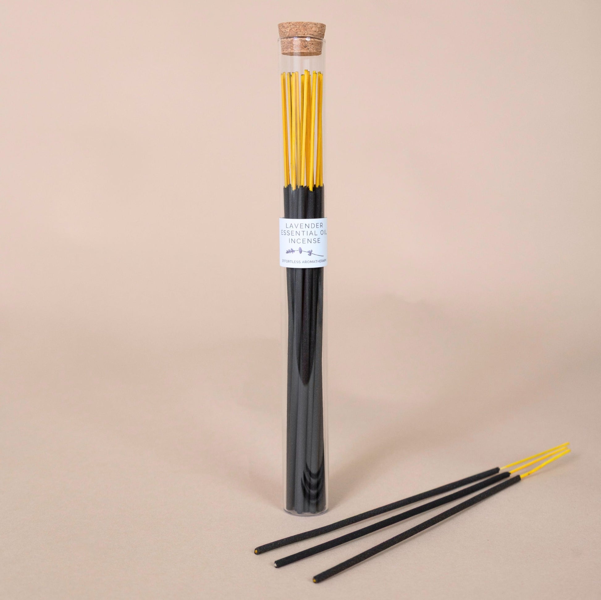 Lavender Incense Sticks tube with three incense sticks arranged in front on a beige surface