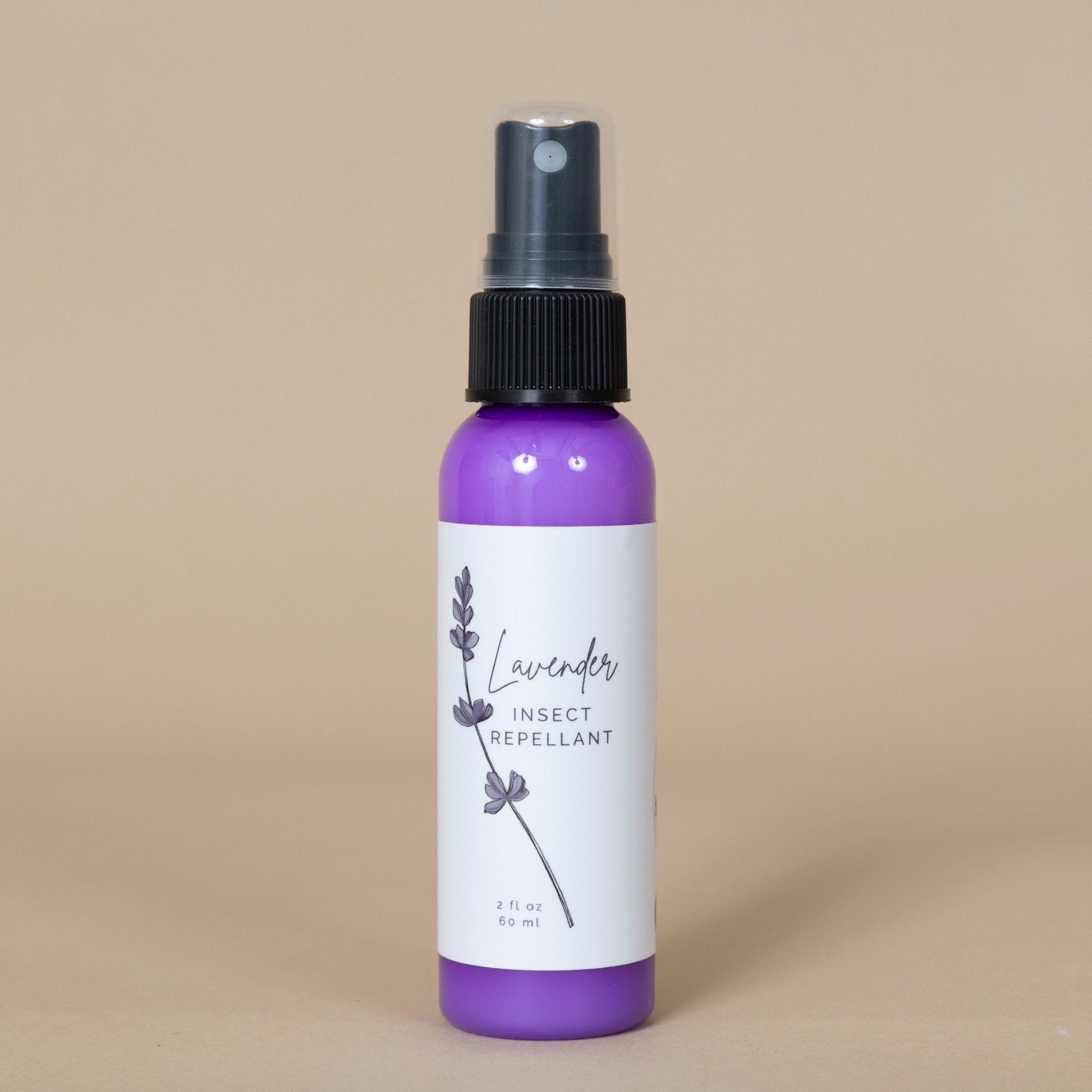 Lavender Insect Repellant spray showcased in an outdoor garden setting next to fresh lavender sprigs