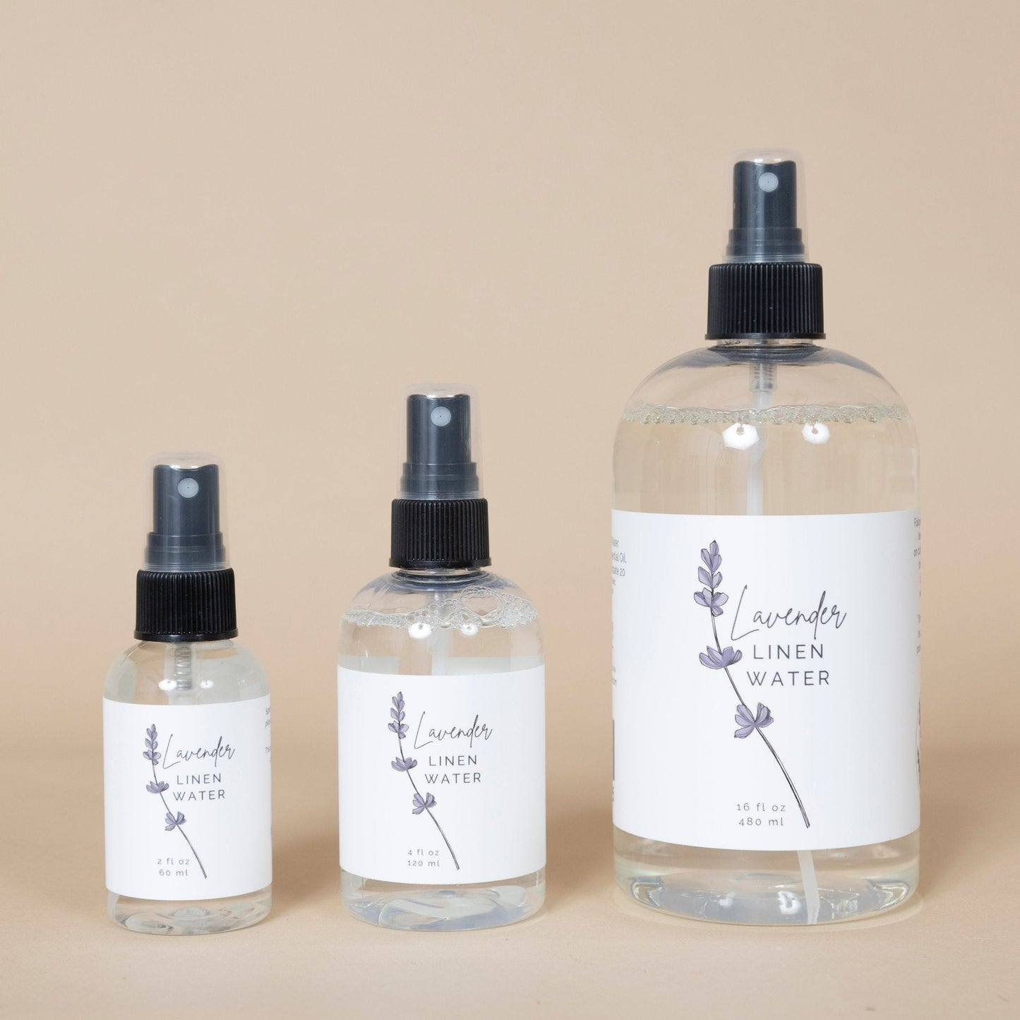 Lavender Linen Water bottle displayed on a wooden surface with fresh lavender sprigs nearby