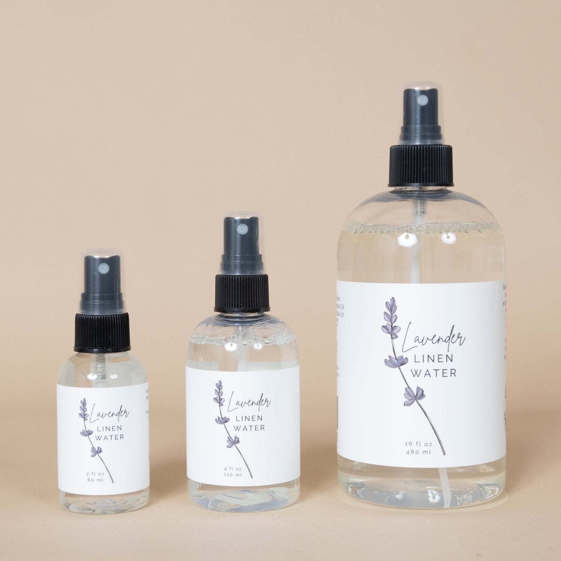 Lavender Linen Water bottle displayed on a wooden surface with fresh lavender sprigs nearby