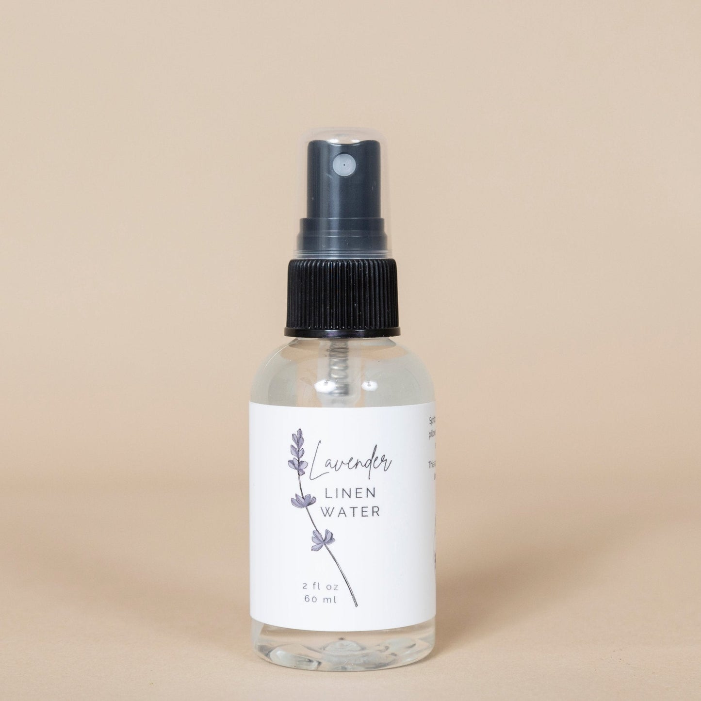Lavender Linen Water spray bottle presented on crisp white linens for fresh, soothing scent