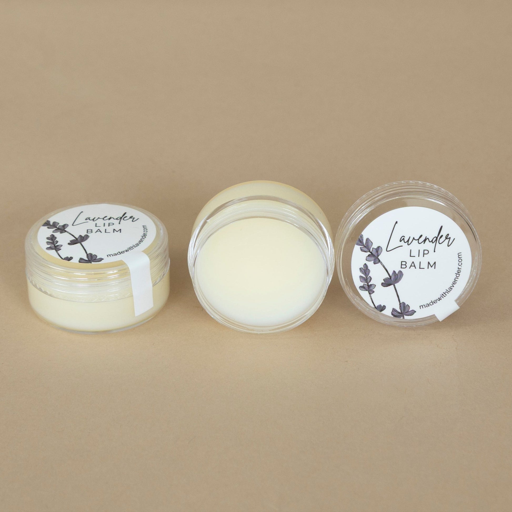 Lavender Lip Balm beautifully arranged next to fresh lavender sprigs for a calming presentation