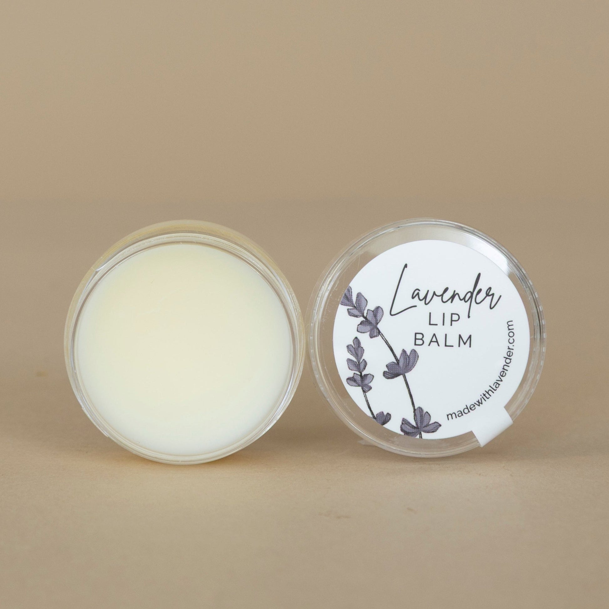 Lavender Lip Balm shown with cap removed to highlight the creamy texture and pale lavender hue