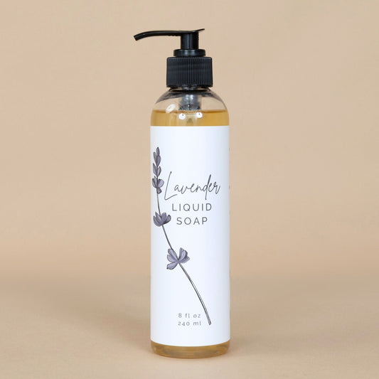 Lavender Liquid Soap in a clear bottle with a pump dispenser, showcasing its soothing purple hue on a clean background