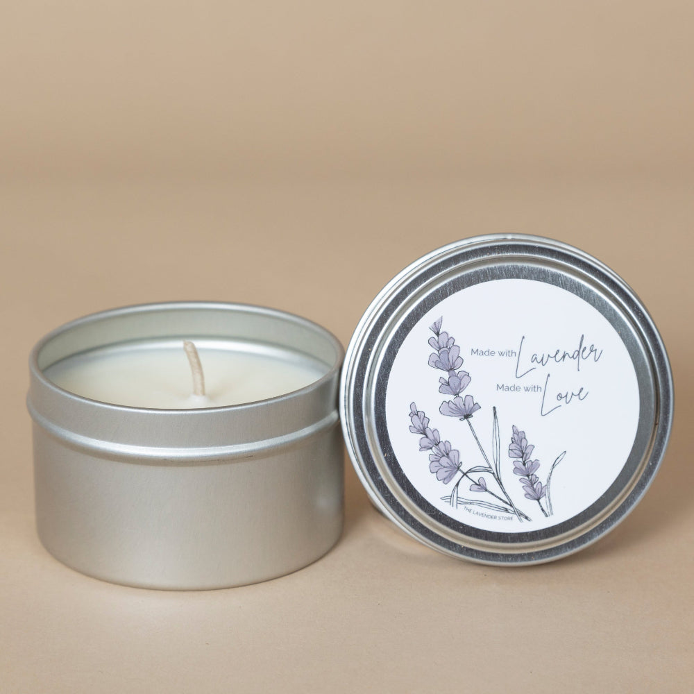 Lavender Travel Tin Candle displayed in a silver tin, showcasing its soothing lavender color and portable design.