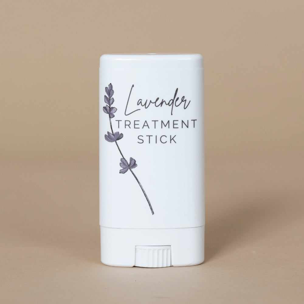 Lavender Treatment Stick shown uncapped to highlight the balm texture and elegant, travel-friendly design.