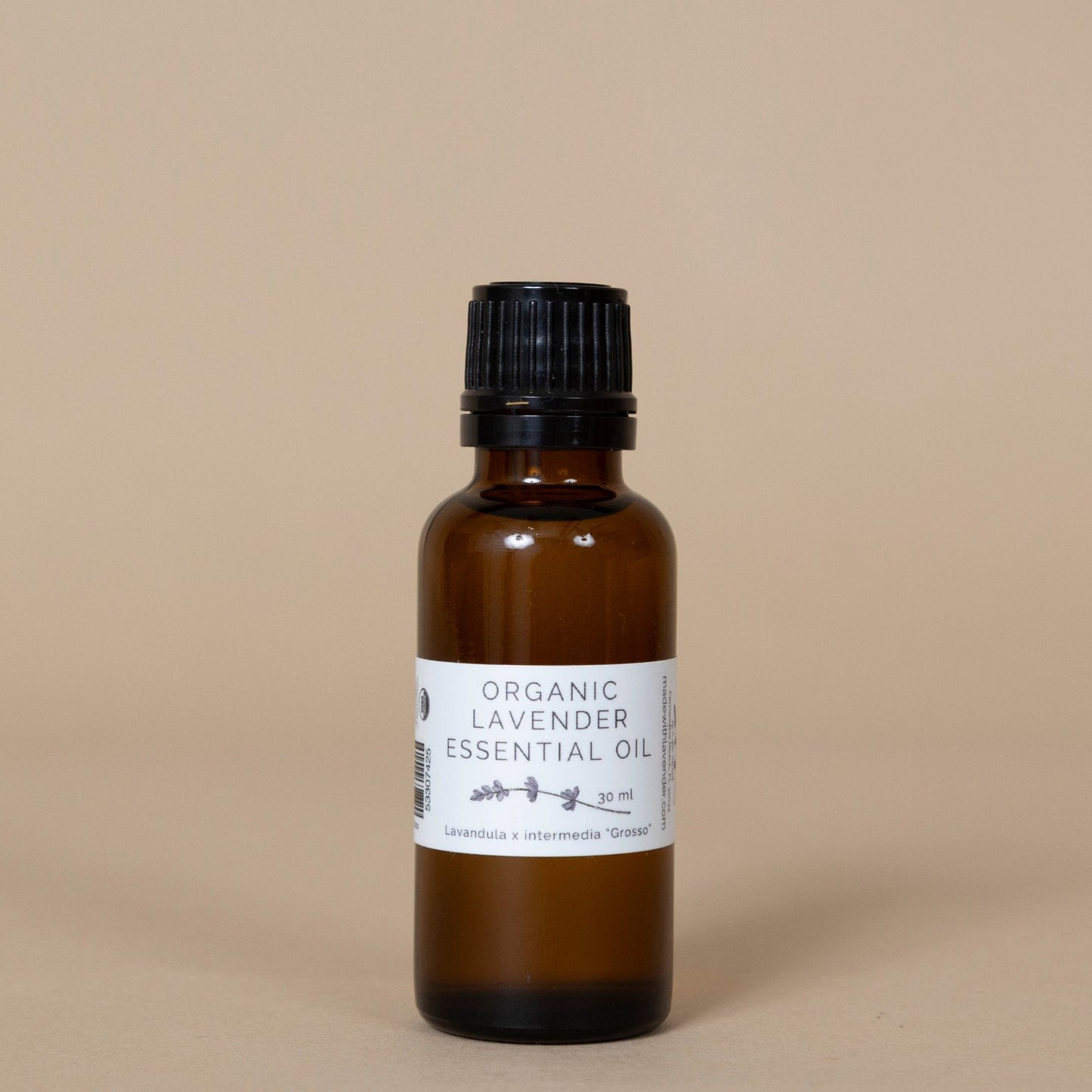 Organic Lavender Essential Oil presented with a minimalist label, placed among aromatic dried lavender flowers