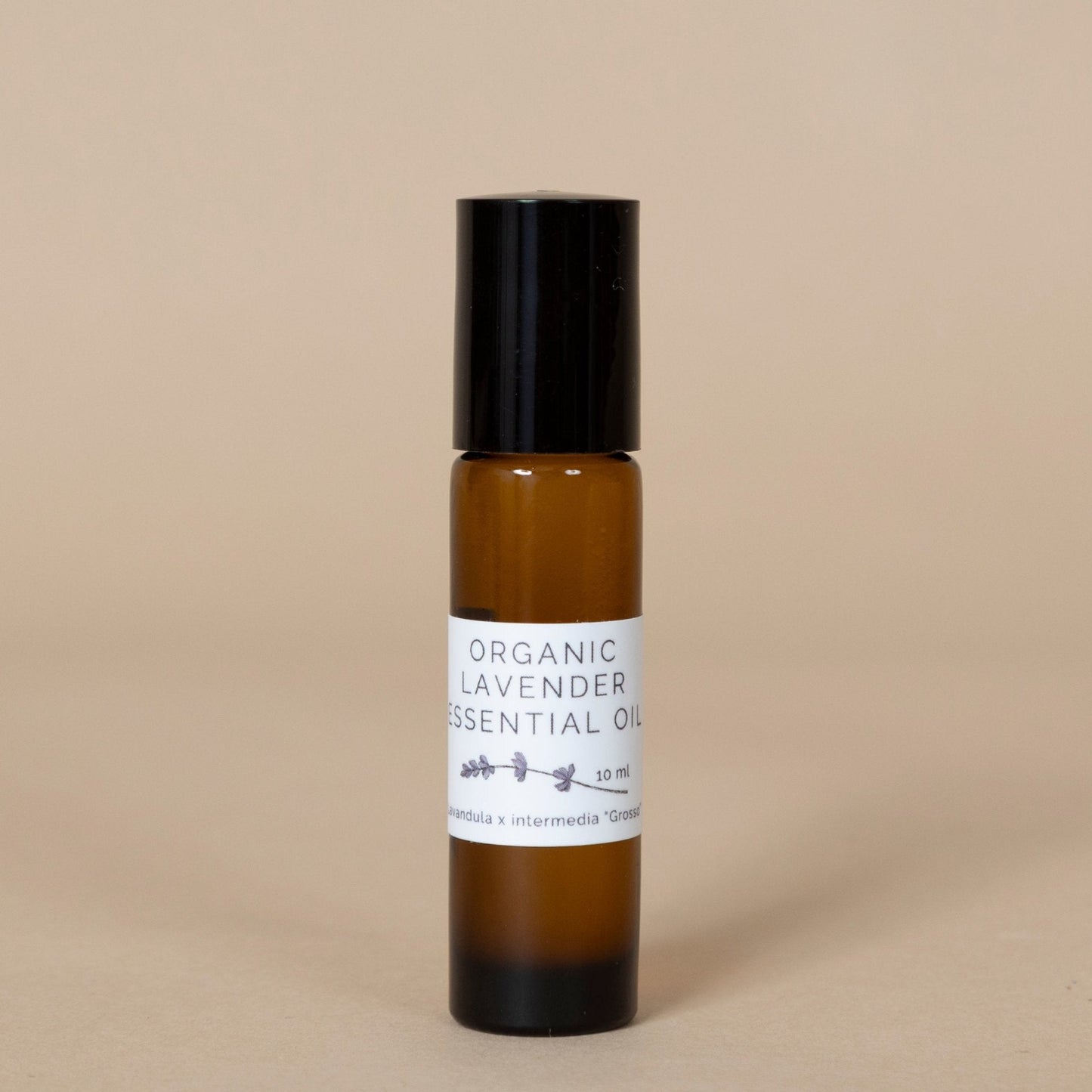 Organic Lavender Essential Oil featured in a close-up shot with calming purple lavender stems surrounding the bottle