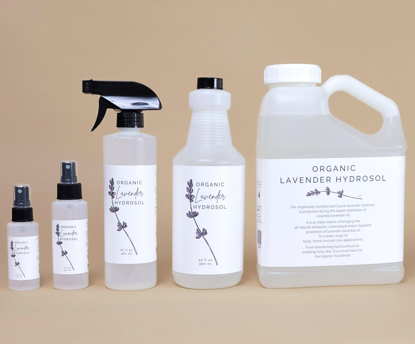 Frosted white bottle of organic lavender hydrosol on a beige backgrouud